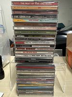 Full stack of CDs on acrylic riser
