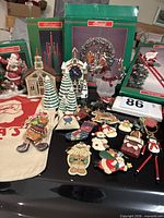 Overview of boxed decorations, ornaments, musical clock, ceramic trees, tote and lantern