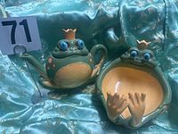 Teapot and matching bowl displayed together