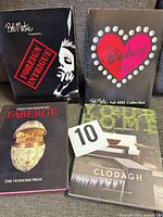 Group shot of two Bob Mackie press kits, Faberge book, and Clodagh book