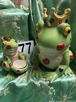 Both frog ceramics side by side showing size difference and decorative details