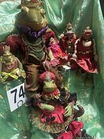 Group shot of all six frog shelf sitters displayed on fabric