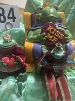 Front view showing ceramic frog prince cookie jar and both Russ shelf sitter dolls