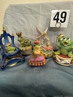 Group shot showing all five frog prince musical figurines