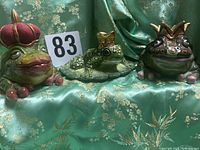Front view of all three ceramic crowned frog pieces