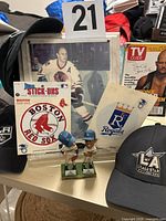 Group shot showing both Kings caps, framed Bobby Hull plaque, Dodgers double bobblehead, two MLB stickers, TV Guide