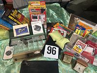 Overview of mixed items including books, clocks, organizer, playing cards, closet organizer pack, pen case, labels