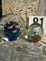 Both glass paperweights side by side