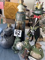 Group shot of all five crowned frog statues showing relative sizes and features