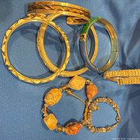 Group of bracelets showing bangles, enamel bangle, link bracelet, beaded stone bracelets