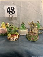 Group shot of all five frog prince musical figurines