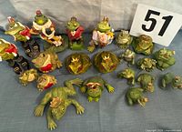 Group shot of the 19 assorted frog prince figurines