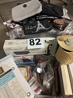 Overview of boxed hair straightener, shower curtain, soaps, sponges, nail sets, hosiery and straw visors