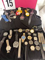 Group shot of all watches laid on black cloth