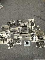 Entire group of twenty photographs displayed on grey surface