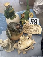 Group shot of all frog prince decor pieces displayed on cloth