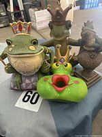 Group shot of four frog décor items