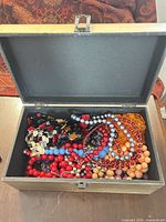 Open jewelry box displaying assorted necklaces