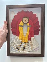 Front view of framed macramé headdress art