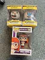 Group shot of three boxed Funko figures: Cuphead, Mugman, Marilyn Thornhill