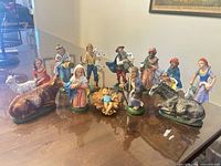 Full group of 12 painted resin nativity figures