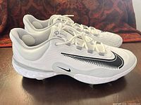 Full side view of both cleats showing color, style and outsole