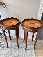 Pair of matching round wooden side tables
