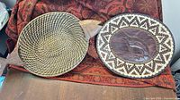 Fish-shaped woven wicker plaque and round swordfish plaque
