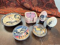 Group shot showing dishes, coasters in holder, and eggs on stands