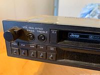 Front view showing controls, Jeep logo, cassette slot