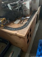 Overall view of plywood playhouse with roadway top and window cutouts