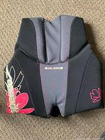 Back view showing Recre8 branding and floral graphic