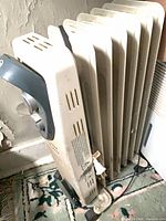 Side view showing heater fins, wheels, power cord, overall wear