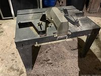 Overall view of plastic router table with legs and guard