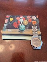 Watch beside folded Gucci felt pouch, front view