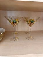 Three fruit martini glasses on shelf