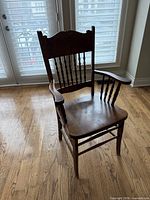 Full view of wooden pressback armchair front-left angle