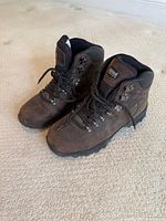 Oblique view of both boots showing uppers, lacing and soles