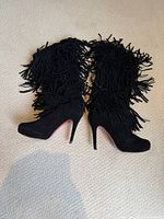 Full side view of both boots showing fringe and heel