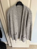Full view of grey Marc Cain Sport cardigan on hanger