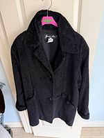 Front view of black Sunny Choi jacket on hanger