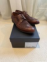 Overall view of shoes on top of box, showing style and included box