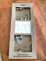Front of unopened Groe 3-piece bath set packaging showing contents through cut-outs