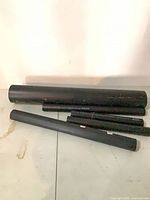 Five black ABS pipes of varying lengths and diameters