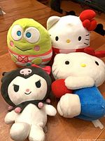 Group shot of four Sanrio plush dolls