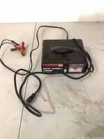 Battery charger with cables visible