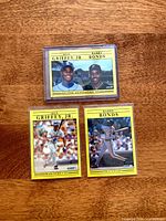 All three 1991 Fleer cards in sleeves: dual Griffey/Bonds card on top, single Griffey and Bonds beneath