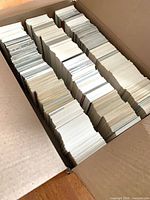 Open cardboard box showing three rows of hockey cards