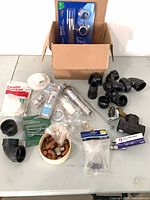 Overall view of boxed plumbing parts and loose fittings