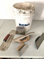 All items: bucket and five trowels/floats displayed